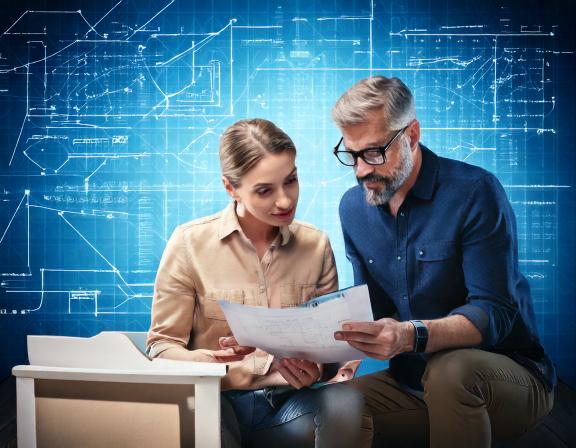 Firefly man and woman looking at assembly instructions and furniture parts against a conceptual back (1)